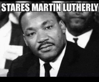 a black and white photo of martin luther king jr. in a suit and tie