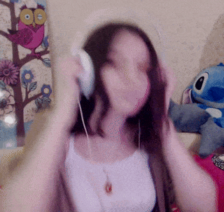 a blurry picture of a woman wearing headphones in front of an owl