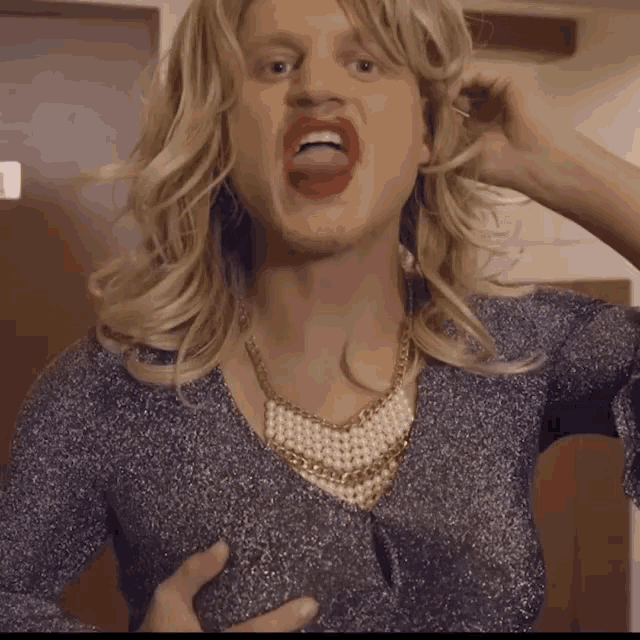 a man wearing a wig and a pearl necklace