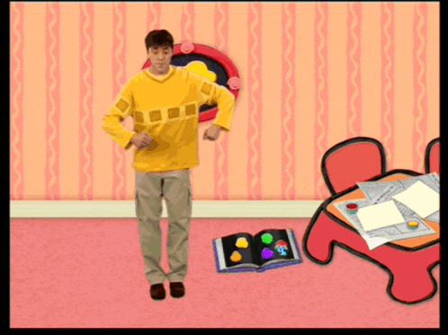 a man in a yellow shirt is standing in a room