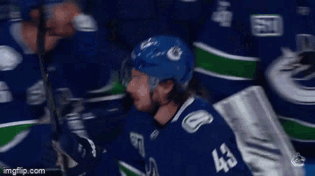 a hockey player wearing a blue jersey with the number 43