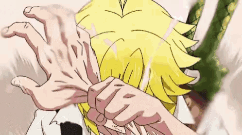 a close up of a person 's hand holding another person 's head .