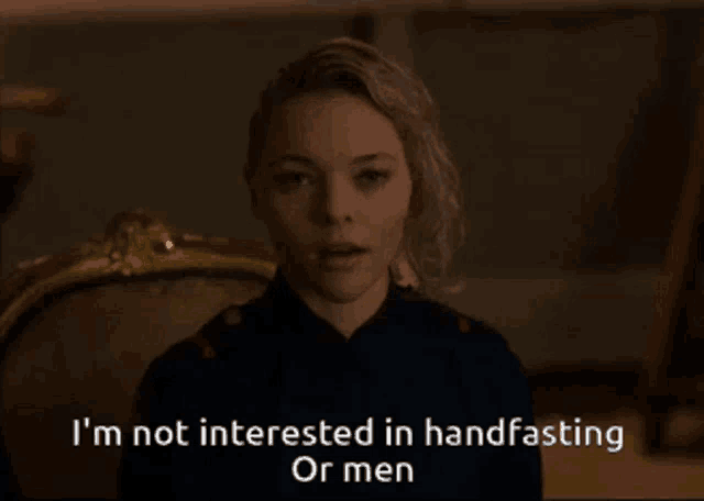 a woman sitting in a chair with the words i 'm not interested in handfasting or men