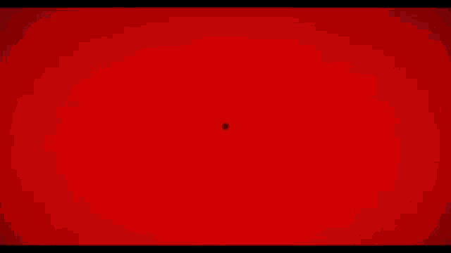 a red light is shining through a circle of wires on a red background