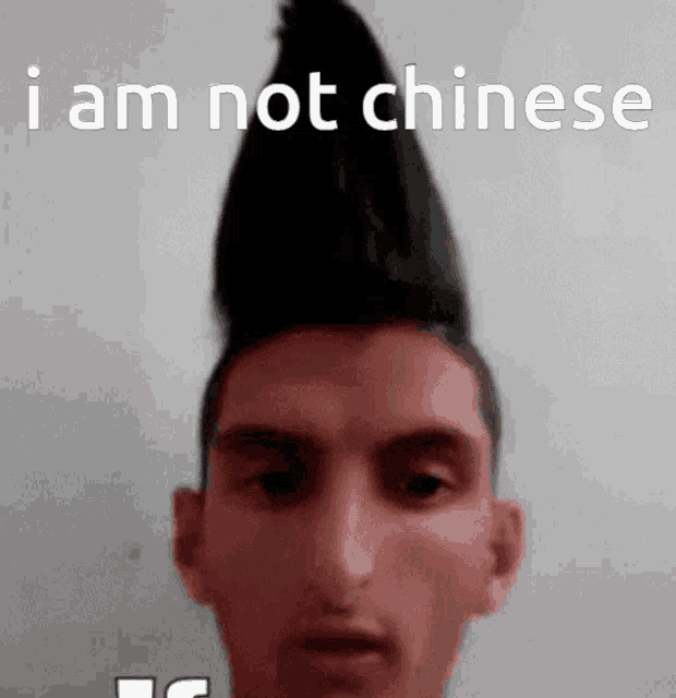 a man with a mohawk on his head says i am not chinese