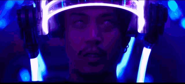 a close up of a man wearing a helmet with lights on his head