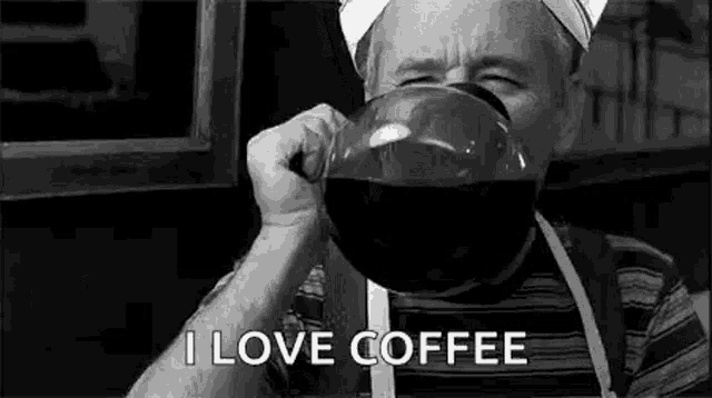 a man is drinking a large cup of coffee from a coffee pot .