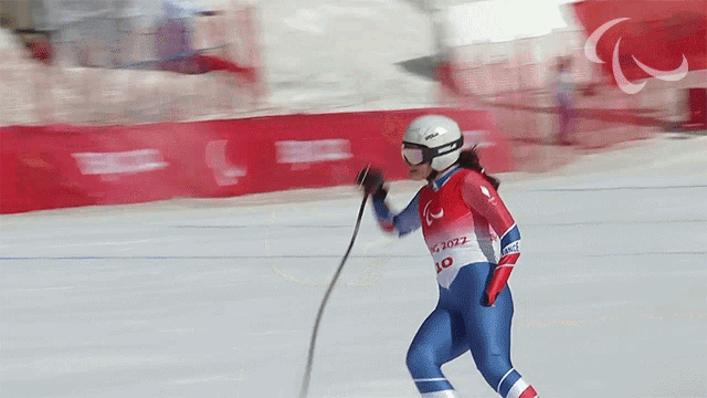 a skier wearing a red white and blue outfit with the year 2012 on it