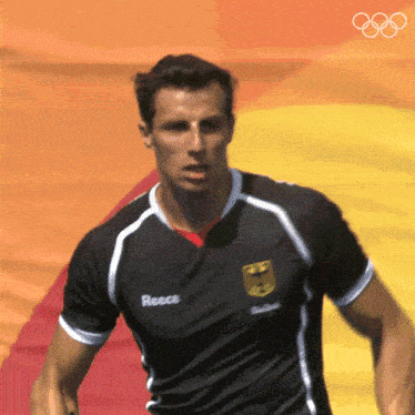 a man wearing a black shirt with reece on the front