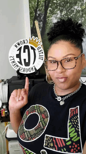 a woman wearing glasses and a t-shirt that says lol