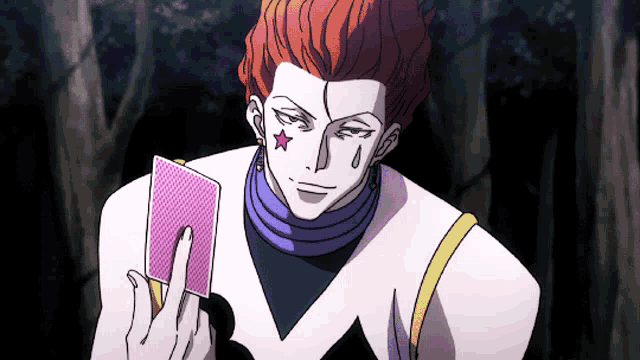 a man with red hair and a star on his forehead is holding a card