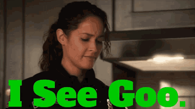 a woman in a police uniform is standing in front of a sign that says " i see goo "