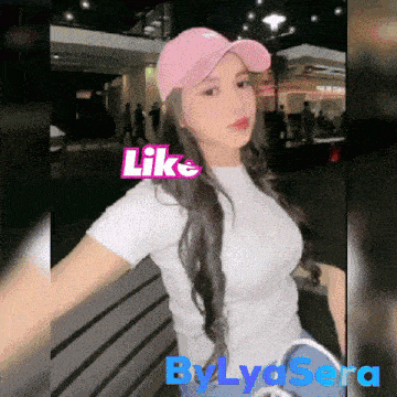 a woman wearing a pink hat and a white shirt with the words like by lysera below her