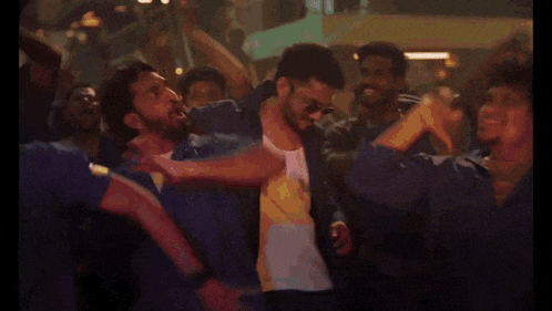 a man is dancing in front of a crowd of people .