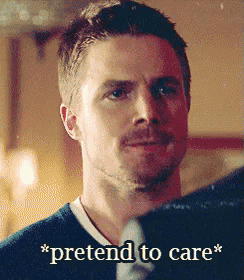 a man in a blue shirt and tie says " pretend to care " in front of him