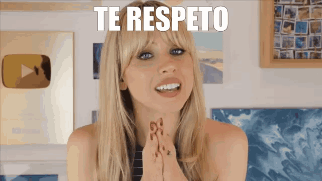 a woman with blonde hair and blue eyes is smiling and says te respecto