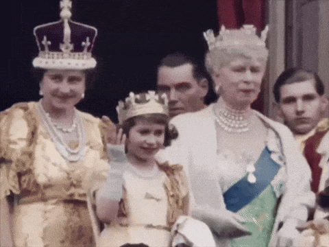a woman wearing a crown is standing next to a little girl