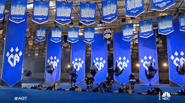 a bunch of banners hanging from the ceiling that say champions