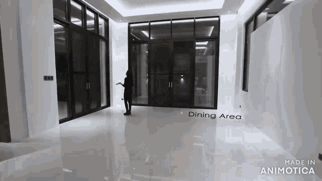 a woman is standing in a large room with the word dining area on the floor