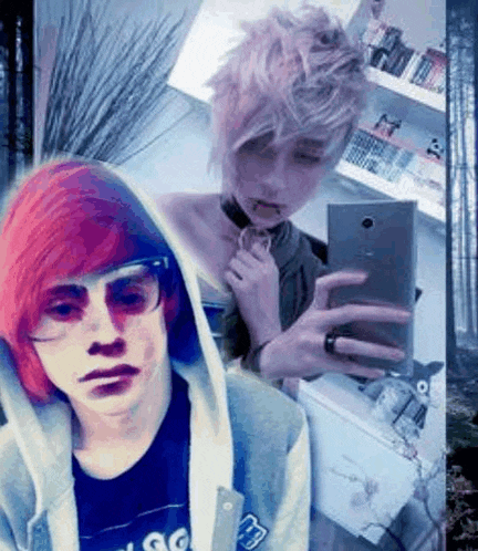 a boy with red hair is taking a selfie with a phone .