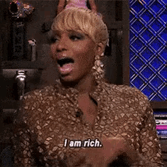 a woman wearing a party hat says i am rich