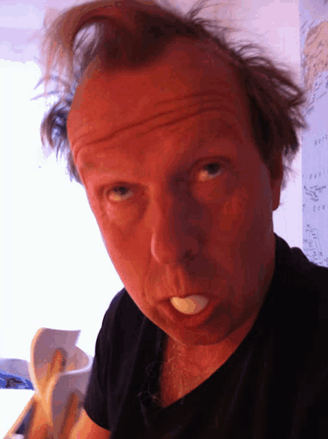 a close up of a man 's face with a banana peel in his mouth