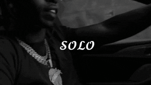 a black and white photo of a man driving a car with the word solo written on the bottom