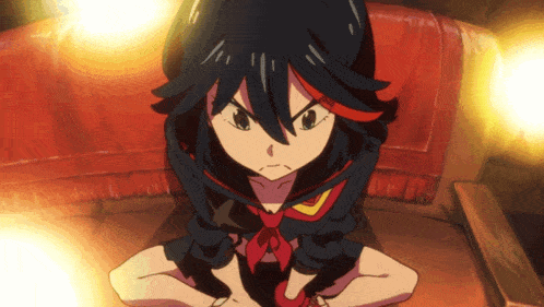 a girl with black hair and red highlights is sitting on a chair