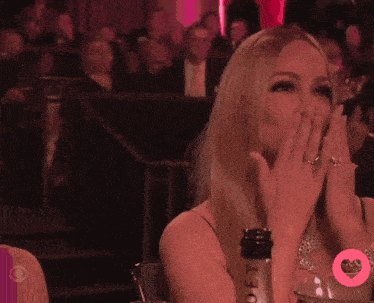 a woman with a ring on her finger is covering her mouth