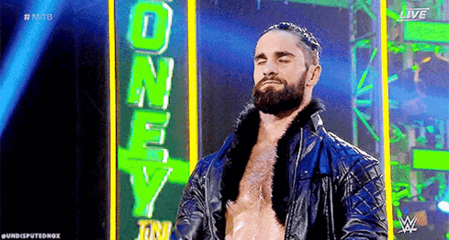 a man with a beard is standing in front of a sign that says `` one way '' .