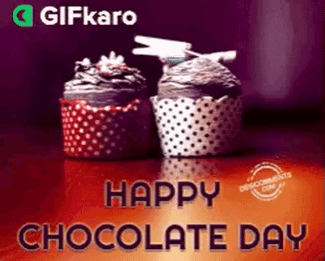 two cupcakes are sitting on a table with the words happy chocolate day written above them .