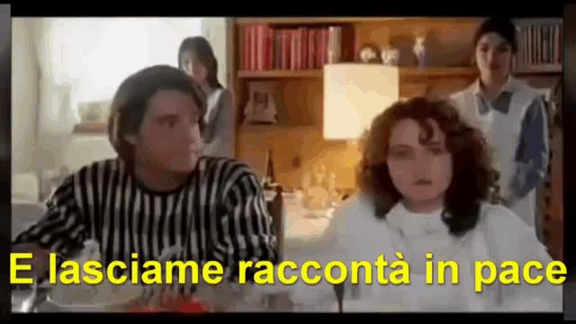a man and a woman are sitting at a table with the words " e lasciami racconta in pace " written in yellow