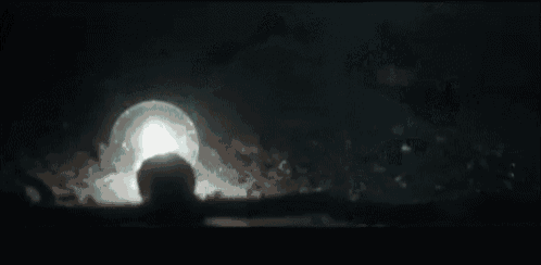 a person is swimming in a pool with a light coming out of it .