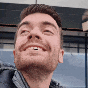 a close up of a man 's face with his eyes closed
