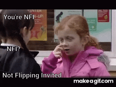 a little girl in a pink jacket is holding her nose .