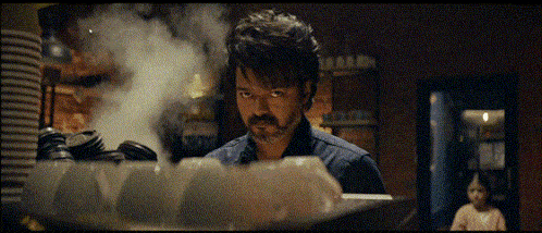 a man with a beard is standing in front of a steaming pot