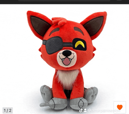 a red stuffed animal with an eye patch and a heart on it