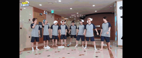 a group of men are standing in a room with a sign that says ' sbs love ' on it