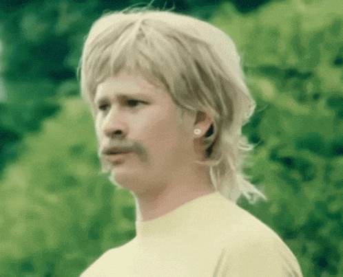 a man with a mullet and a mustache is wearing earrings