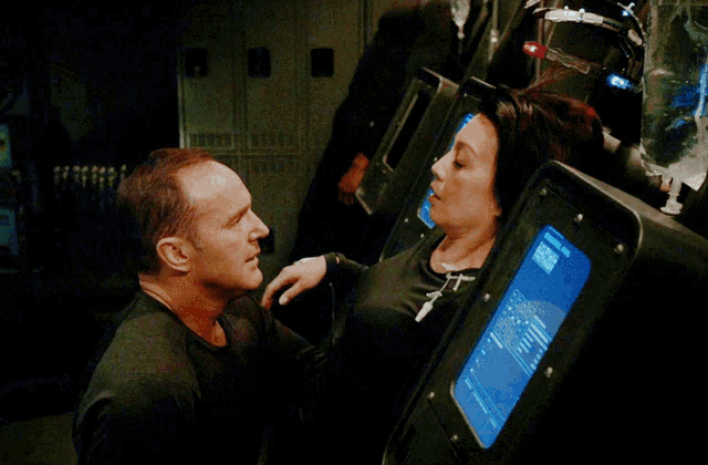 a man and a woman are looking at each other in front of a display that says 8888