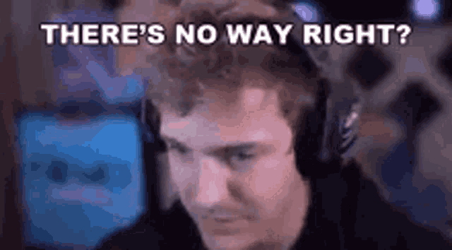 a man wearing headphones is sitting in front of a computer screen and says `` there 's no way right ? ''
