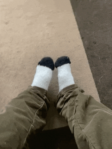 a person wearing a pair of socks that look like a pair of sheep 's feet .