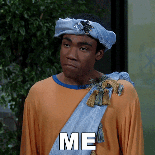 a man wearing a turban and a scarf has the word me on his shirt