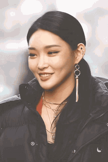 a close up of a woman wearing a black jacket