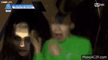 a group of people are standing next to each other and one of them is wearing a green shirt