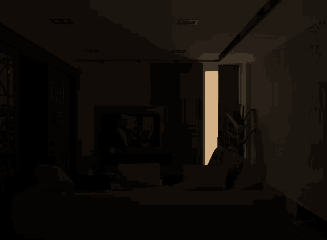 a dark room with a light coming through a doorway