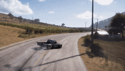 a black truck with the word ford on the side is driving down a road