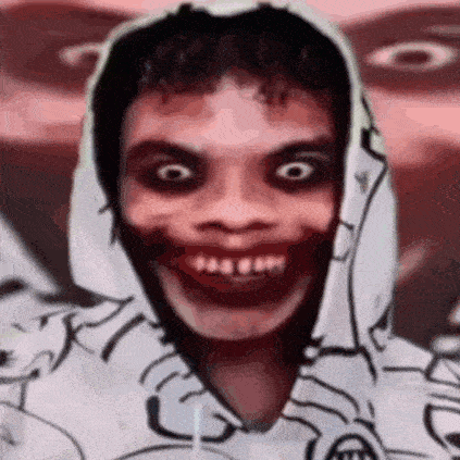 a close up of a person wearing a hoodie with a scary face painted on it .
