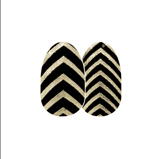 a pair of black and gold nails with a chevron pattern