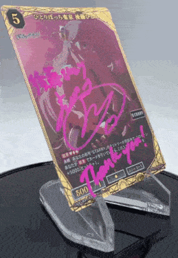 a card with the number 5 on it is signed by a person